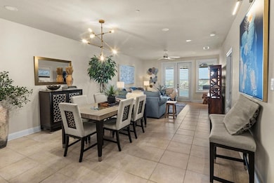Dining area featuring baseboards, light tile patterned flooring, ceiling fan with notable chandelier, and recessed lighting
