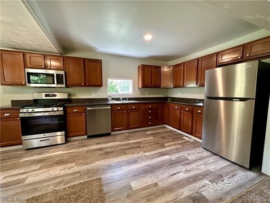 Kitchen featuring light hardwood / wood-style floors, appliances with stainless steel finishes, and sink