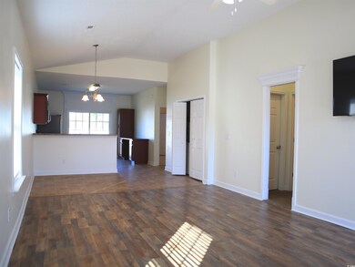 Unfurnished living room with ceiling fan with nota
