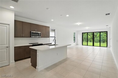 Kitchen with stainless steel microwave, range with