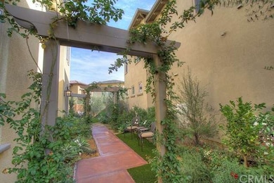 Rose covered entry arbors with mature landscaping.