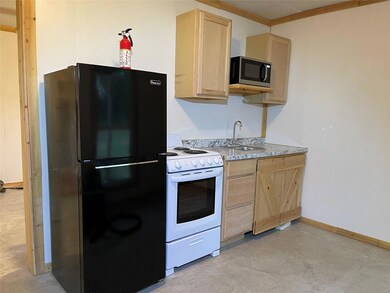 Kitchen featuring white range, light brown cabinet