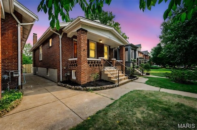 View of front facade with brick siding, a yard, and a porch