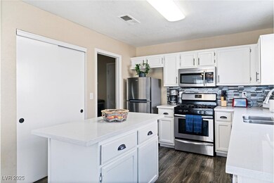 Kitchen with a sink, dark wood finished floors, li
