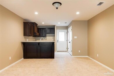 Kitchen featuring dark brown cabinetry, a peninsula, visible vents, recessed lighting, and baseboards
