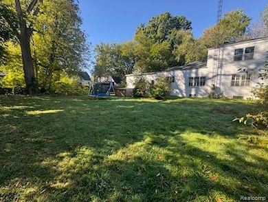 View of green lawn featuring a trampoline