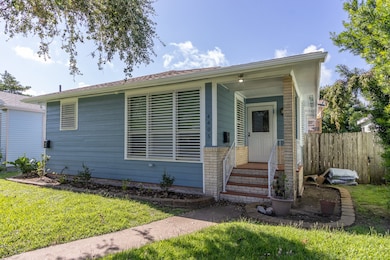 This is a single-story home, featuring a covered entrance, white trimmed windows, and a well maintained front lawn. The property includes a fenced backyard and centrally located in a residential neighborhood.