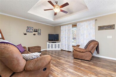 Vinyl plank flooring, ceiling fan and bay window.