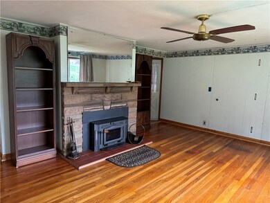 A view of the living room with wood burning insert