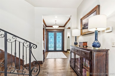 Foyer entrance featuring french doors, dark wood-t