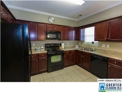 Welcoming Kitchen with rich cabinets, all Black Ap
