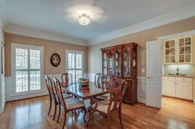 Large dining room to the left of the foyer. Overlooks the front porch. Deep crown molding, chair rail, hardwoods. And the layout is perfect...just off the butler's pantry and kitchen. Opens to foyer and family room. You could host a MASSIVE party.