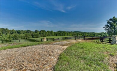 Main entrance with stone drive, 3-board fencing an