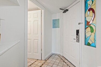 Foyer featuring a textured ceiling, electric panel