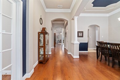 Once indoors, you're greeted with high ceilings, rich hardwood floors, and a neutral palette with pops of color. As seen here to the left are the full-light french doors leading to the dedicated study, with the formal dining room to the right. The hallway leads to the secondary bedrooms and the first of three full bathrooms, while the butler's panty joins the formal dining room to the kitchen.