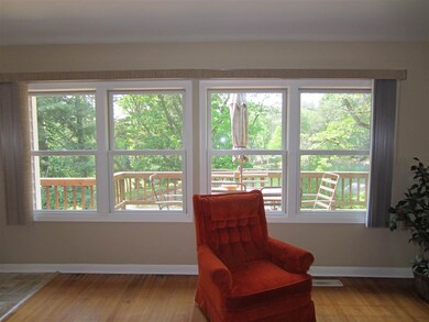 The spacious Living Room has windows all along the
