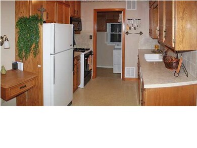 Kitchen has full tile backsplash and nice counters