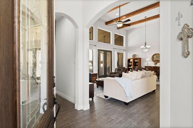 Architecturally appealing entry with arched doorways and exposed beams.