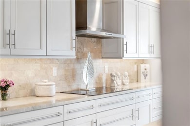 Kitchen with backsplash, wall chimney range hood, 