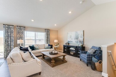 Main level view from the living room! This home will include a cozy, corner fireplace. Model home photo. Colors and selections may vary.