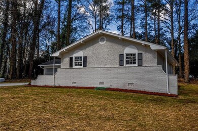 View of side of home with a yard