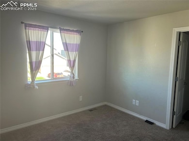 Unfurnished room with carpet flooring and baseboards