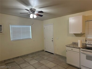 Kitchen with white range with electric stovetop, c