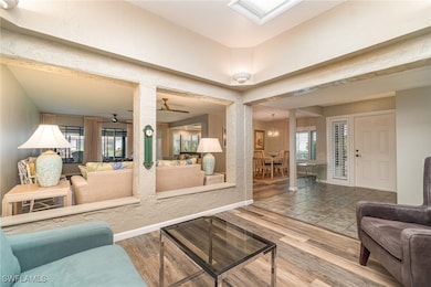 Living area with wood finished floors, ceiling fan