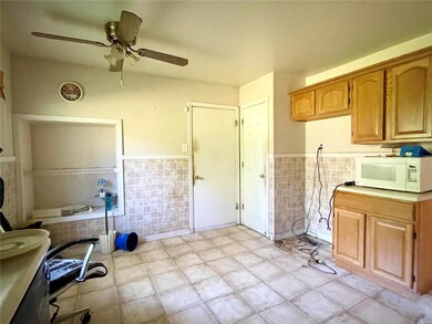 Kitchen w/pantry and garage access leading to base