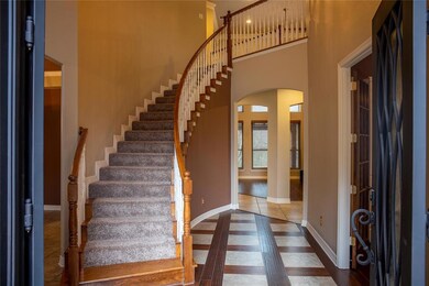 Stately enterance with wood floor with tile enlay,
