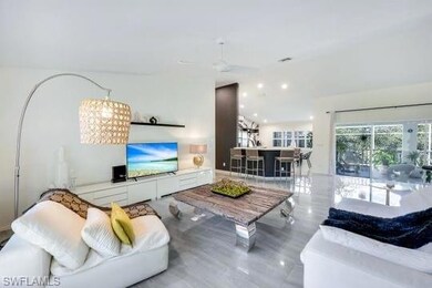 Living room with ceiling fan and lofted ceiling