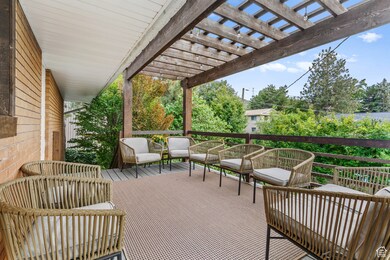 View of patio with a deck and a pergola