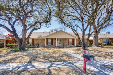 Single story brick, ranch style home with mature t