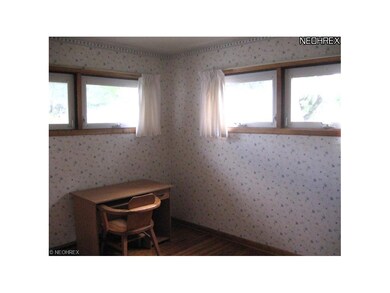 Bedroom 2 features hardwood floors.