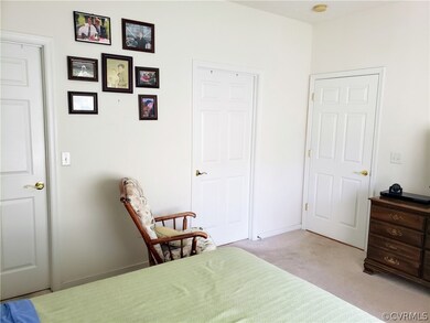 Primary bedroom view to WIC door, bathroom door an