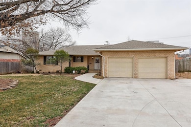 Ranch-style house featuring a shingled roof, fence