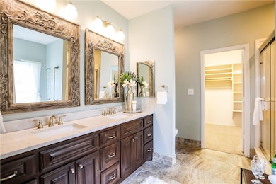 Master has new custom vanity with double sinks and a lot of storage, new lighting, new tile with heated floors, new mirrors, freshly painted.