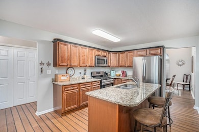 BEAUTIFUL KITCHEN WITH GRANITE COUNTERS AND STAINLESS STEEL APPLIANCES.