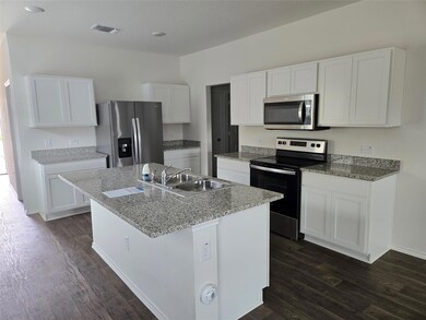 Kitchen with appliances with stainless steel fini