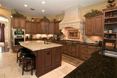 The gourmet kitchen features: Built in refrigerato