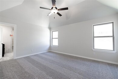 Empty room featuring ceiling fan, baseboards, high vaulted ceiling, and light carpet