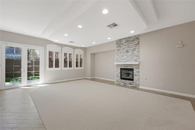 Unfurnished living room with a fireplace and recessed lighting