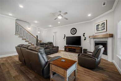 Living room has gas fire place, crown moulding, LE