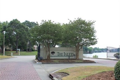 Well-maintained gated entrance into The Inlets