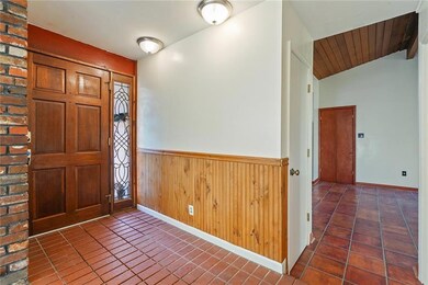 Brick Foyer and pretty leaded glass door side pane