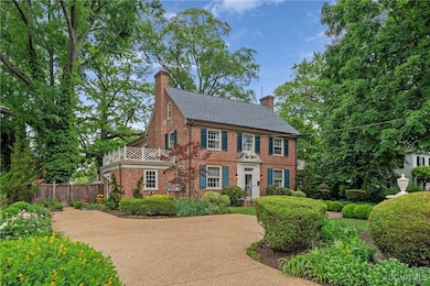 View of front facade featuring a chimney, brick si