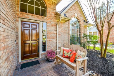 Covered porch elevation with newly stained mahogany door.