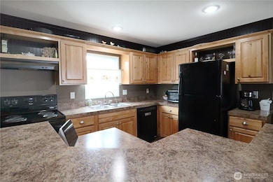 Generous counter space and convenient eating bar make this kitchen both functional and inviting—perfect for casual meals or entertaining.
