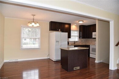 Dining is open to kitchen and living.