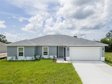 Single story home featuring a front yard and a gar